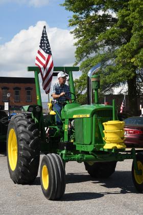 What says America more than a big, green John Deere tractor carrying the American flag?