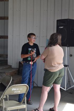 Collin telling the judge about his ferret in the small animal show. Photo by Beth Sparrow