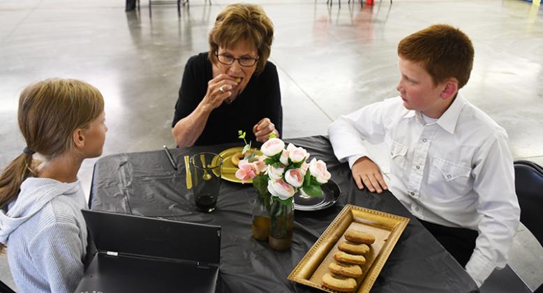 Bentley McLean and her cousin Briar Crawford served donuts at the Culinary Challenge. The duo were named Reserve Grand Champion in the intermediate division. Polk County News Photo by Rick Holtz