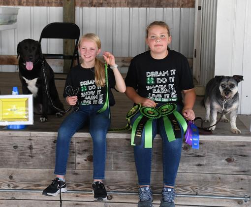 Emma Frazier (left) with her dog, Maisy, and Marivel Nyberg with her dog, Oscar, participated in Thursday's Dog Show at the Polk County Fair. Polk County News Photo by Rick Holtz