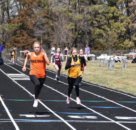   Right:Alexis Burritt and Danica Watts finish the 4x100m relay. PCN photos by Beth Sparrow.