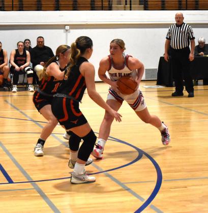 Courtney Carlstrom faces two Dorchester defenders in the conference game Friday afternoon. PCN photo by Cienna Friesen.