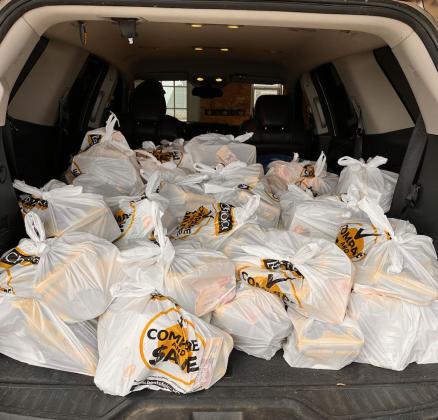 The back of this SUV is piled with sacks of food to be delivered to schools for the backpack program. Photo provided.