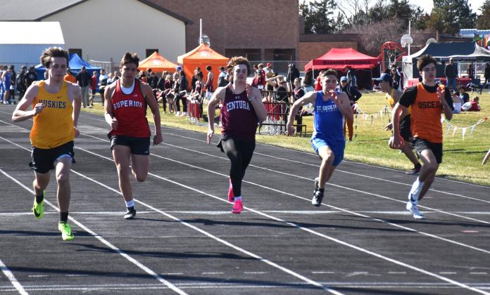 Blake Schmidt (SRC, far left) and Jackson Winslow (OSC, far right) run in the 100-meter dash. PCN photo by Beth Sparrow.