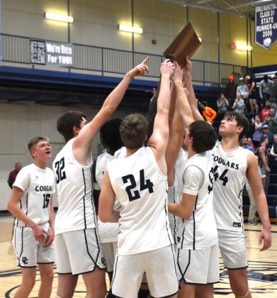 ABOVE: Cross County boys won their district game and qualify for the state tournament for the first year ever. BELOW RIGHT: The team raises the plaque after the win. PCN photos by Beth Sparrow.