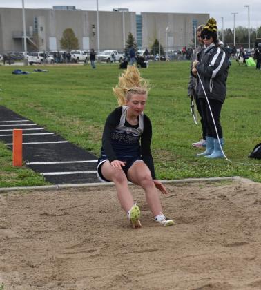 Right: Finley Peterson lands her triple jump. PCN photo by Beth Sparrow.