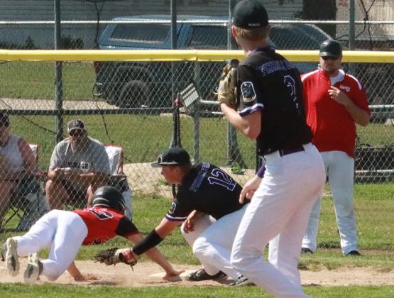 Layne Donner slaps the tag in the Aurora Post 42 base runner as he is called out on the throw from SOS pitcher Tommie Rediger. PCN photo by Ken Kush.