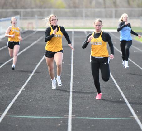 Olivia Adams and Kaylei Perry (left to right) run in the 200m dash. PCN photo by Rick Holtz.