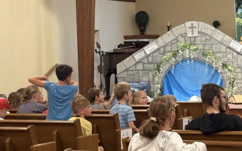 Vacation Bible School is going on now at Stromsburg Evangelical Free Church. Kids here are singing along with Summer Lukasiewicz and Lexi Eller (below) and answering what they learned (above). PCN photos by Beth Sparrow.