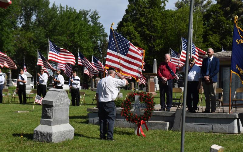 Commander Perry Noyd salutes the wreath after placing it at Memorial Day on Monday in Stromsburg. Speakers behind him were Pastor Craig Pinley, Adjutant Owen Kinnan and Pastor David Owens. PCN photo by Beth Sparrow