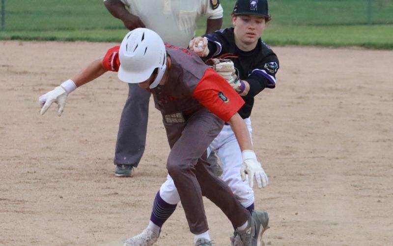 SOS second baseman Ruger Webb completes the run down by tagging the Valpariaso runner out during action last Thursday night in Osceola. PCN photo by Ken Kush.