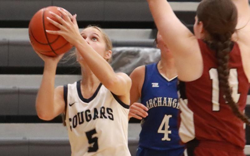 The Cougars Edie Peterson works her way under the basket and scores two of her team-high 11 points in the CRC’s 60-51 win over the Goldenrod Conference on Sunday. PCN photo by Ken Kush.