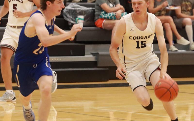 Cross County’s Sawyer Anderson drives to the basket as Carter Molt of Riverside applies the defensive pressure. Anderson scored 18, all in the second half to lead the CRC to a 71-61 win over the GRC on Sunday. PCN photo by Ken Kush.