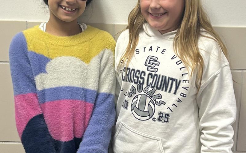 Left: Four girls helped set the military child’s table at a Legion Auxiliary meeting. Right: Poppy poster winners were 4th graders Zaara Moore and Scarlet Peterson. Posters were displayed at Economy Hometown Market. Photos provided.