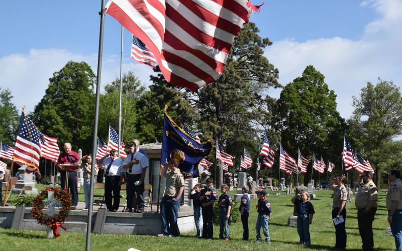 Above: Legion members to the Salute to the Dead firing blanks into the sky. Below: Scouting America members lead the Pledge of Allegiance. PCN photos by Beth Sparrow.