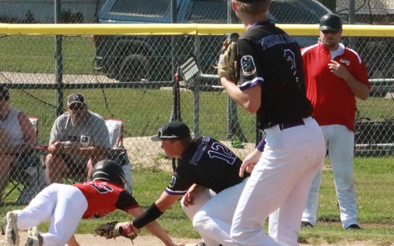 Layne Donner slaps the tag in the Aurora Post 42 base runner as he is called out on the throw from SOS pitcher Tommie Rediger. PCN photo by Ken Kush.