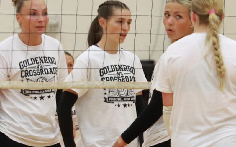 Top photo- Graci Conkling and Samantha Hueske of Nebraska Lutheran await the Goldenrod serve in the fifth set.