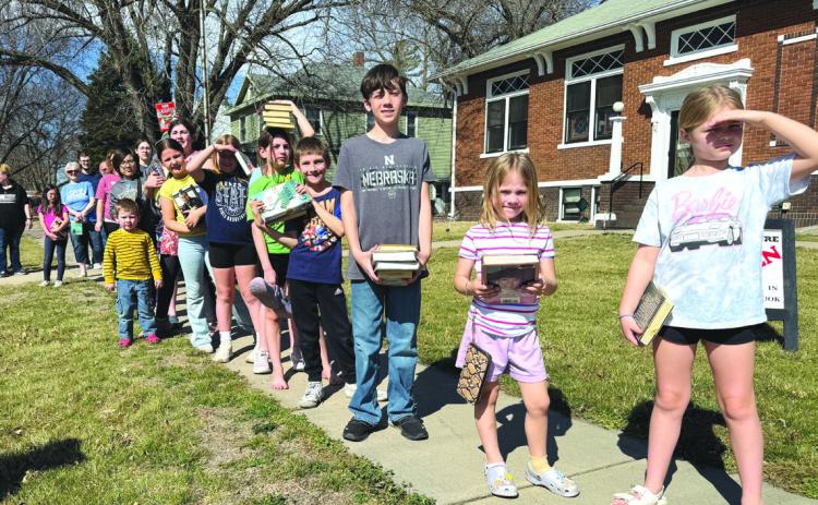 Above: Kids lined up to pass books just like 25 years ago. They ended up just running them. PCN photo by Rick Holtz.
