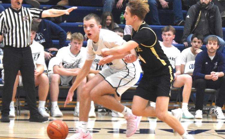 Cross County’s Benson Seim dribbles around the Thayer Central defense. PCN photo by Kirk Sparrow.