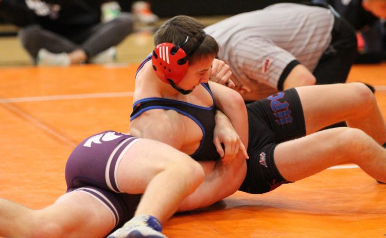 Hudson Urkoski pins his opponent at the meet in Osceola earlier this season. PCN file photo by Travis Lane.