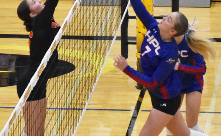 Above- High Plains sophomore Taya Hans looks for the tip winner against the Dorchester defense.