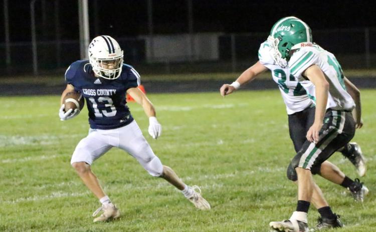 Cross County senior Tyler Shoup (left) takes the ball past two Gator defenders on Thursday night. PCN photo by Travis Lane.