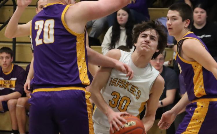 Nixon Thelen (30) tries to split the Tekamah-Herman defense in Monday nights 86-78 OT win at Fremont Bergan Catholic. On Tuesday, the C2 defending State champion Knights rolled to a 76-42 win to end the Huskies season at 12-13. PCN photo by Ken Kush
