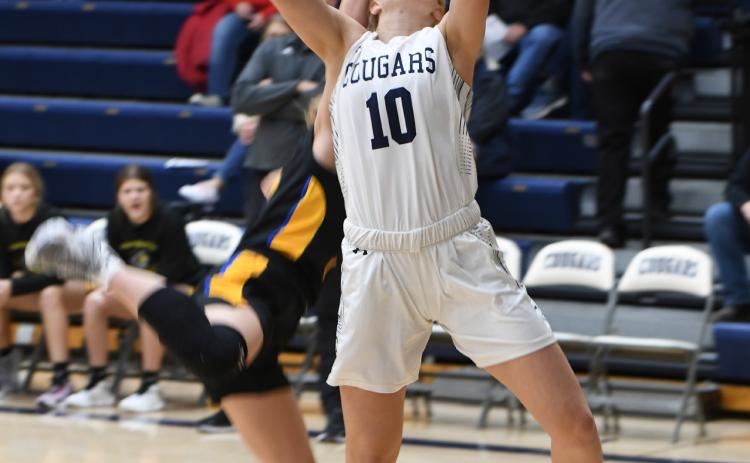 Lilly Peterson absorbs the contact on her way to the basket. The junior scored a career high 26 points in the Cougars' home win on Friday. PCN photo by Rick Holtz