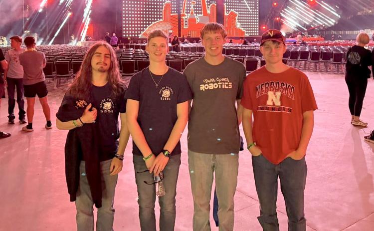 St. Louis MO. was the destination for the 2026 World Robotics last week. The Cross County team of (Left) Brad Lott and Sam Haug were among the competitors. Above- The two Cross County students take a photograph with their coaches, Ashton Holtzen and Marshall Johansen in St. Louis. Photos by Heather Haug.