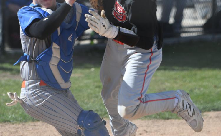 Titan catcher Aden Feezell makes the play at home to save a run on Thursday. PCN photo by Rick Holtz