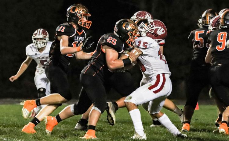 Conner Schnell (#20) blocks for the runner against Fullerton. PCN photo by Blaine Winslow.