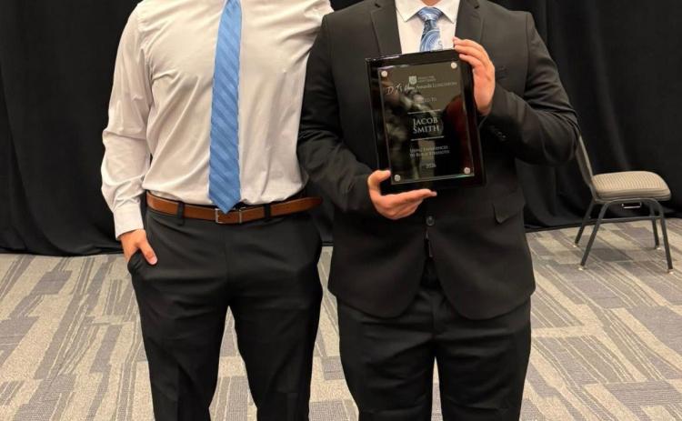 Above: Cross County P.E. teacher and coach, Trent Grizzle (left) is pictured with senior Jacob Smith. Smith recently was honored by the Salvation Army as one of 19 students in the state chosen for the DJ’s Hero Award. Photo provided.