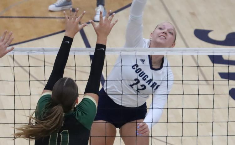 Cross County senior Sydney Hengelfelt (22) powers the attack through the Central City Bison block in Thursday’s win over the Bison. In two games last week, Hengelfelt had 32 kills. PCN photo by Ken Kush.