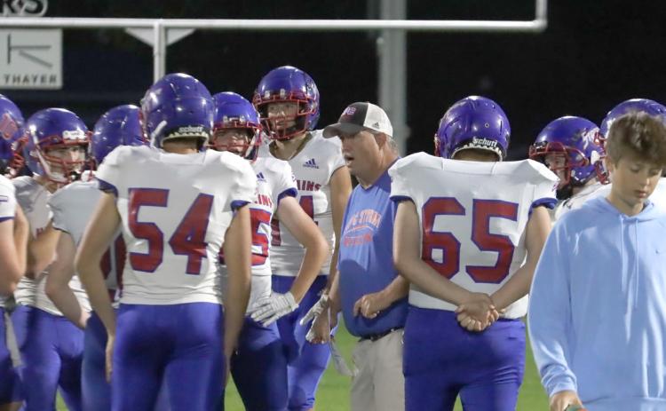 High Plains head coach Greg Wood meets with the team on Friday night during the game at Lawrence-Nelson. On Monday night at the school board meeting in Clarks, discussion included a move to six-man football starting next season due to the low numbers and the safety of the team. PCN photo by Ken Kush.
