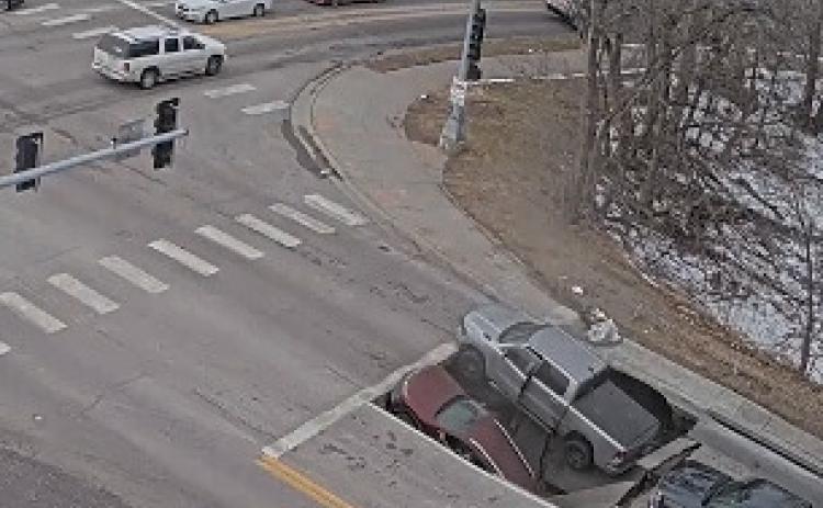 A picture of the sinkhole where two vehicles sunk. It has been fixed and shall reopen Thursday. Photo provided.