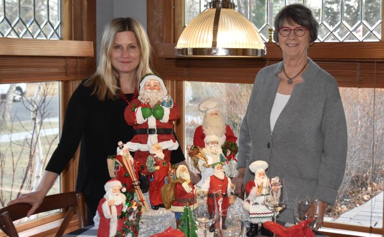 Donna Collins (right) and her daughter Heather display beautiful Santas and a Christmas place setting at the Collins’ home. PCN photos by Beth Sparrow