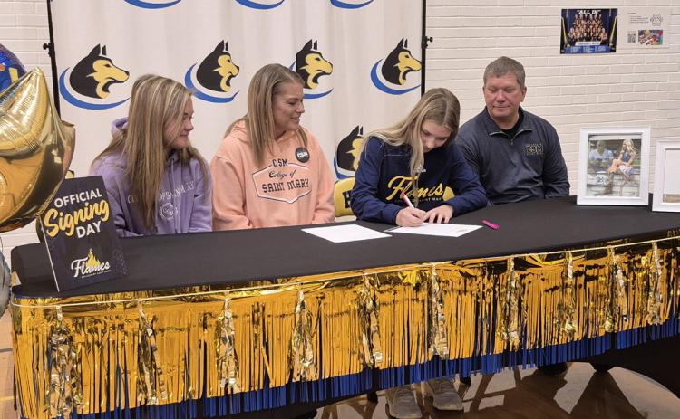 Shelby-RC senior Danica Watts signs her letter of intent to attend College of St. Mary’s and join the Flames Track and Field program. L-R- Sierra Harrison (sister), Shari Watts, (mom), Danica and her dad Chris. PCN photo by Ken Kush.