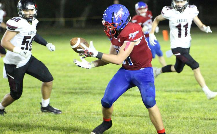 Ayden Hans gets the pitch with some Eagles close by ready to tackle. PCN photo by Travis Lane.