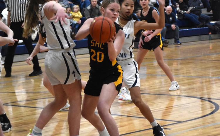 Olivia Frederick tries to hold the ball away from Nebraska Christian defenders. PCN photo by Beth Sparrow.