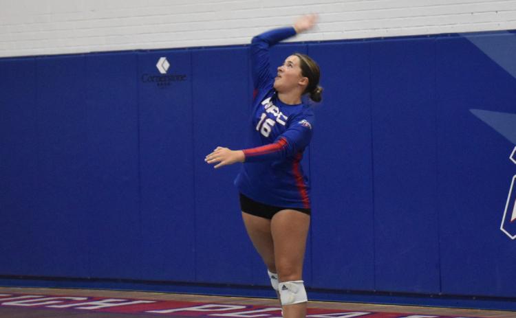 Addison Lindburg serves one against the Mustangs. PCN photo by Beth Sparrow.