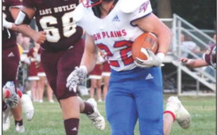 Gage Friesen runs the ball to avoid a tackle by East Butler. Photo provided by yearbook staff.