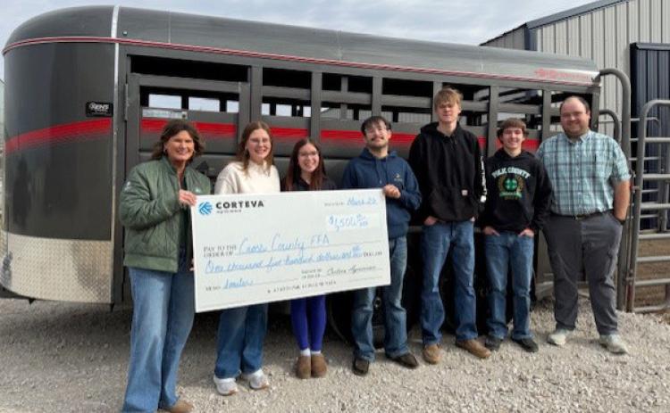 Michelle Roesener of Corteva presents the check to Cross County FFA. From left to right: Roesener, Emarie Bowman, MaHaylee Dotson-Monroe, Yagiz Kerabiyik, Sawyer Anderson, Wyatt Smith, and Joe O’Brien (FFA advisor). Photo provided.