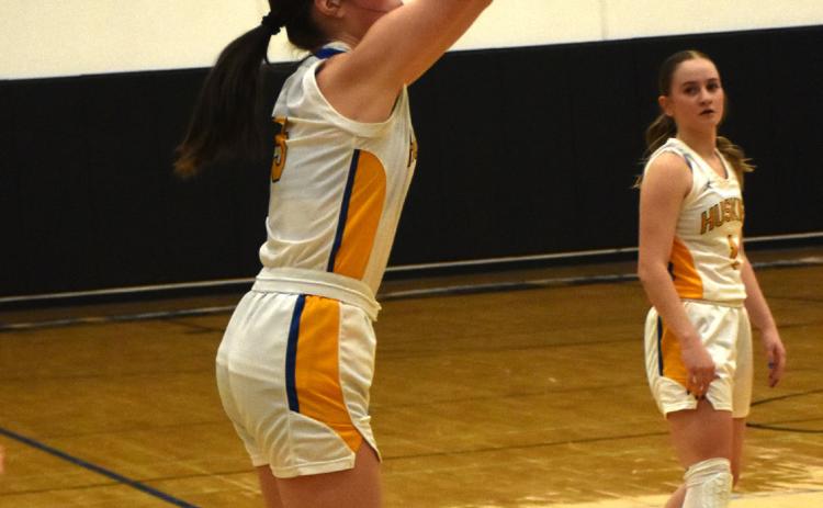 Kaleigh Ruth shoots for three. She put in two in a row to put the Huskies just behind by three at that point in the game. PCN photo by Beth Sparrow.