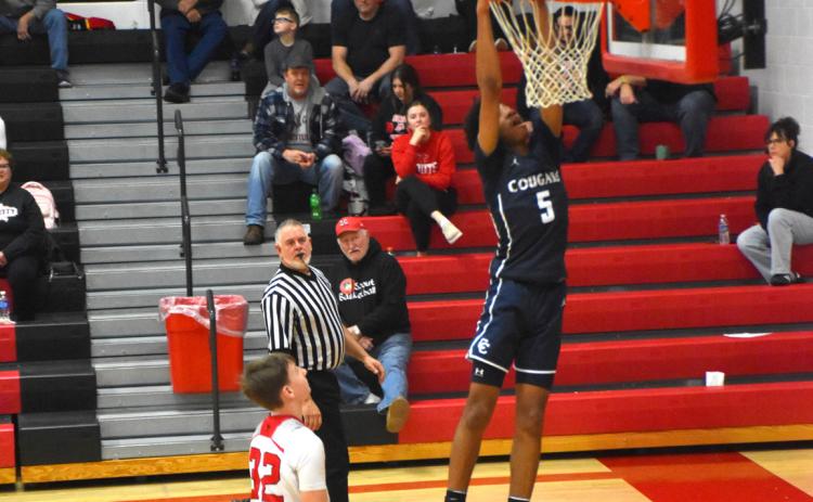 Benji Cooper gets the dunk and pleases the Cougar crowd in David City on Friday. PCN photo by Beth Sparrow.