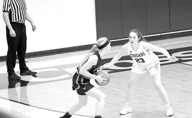 Cross County player Lindee Kelley defends against a Dorchester player in the game last week. Photo by Angie Hild.