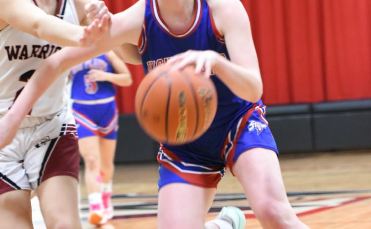 A determined Peyton Hofmann tries to dribble around a Fullerton defender. PCN photo by Rick Holtz.