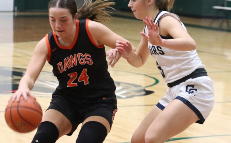 Junior Bella Recker (left) scored 23 points, but Edie Peterson (right) and the Cross County Cougars survived a 53-49 final to the D1-3 finals last Tuesday in Howells. PCN photo by Ken Kush.