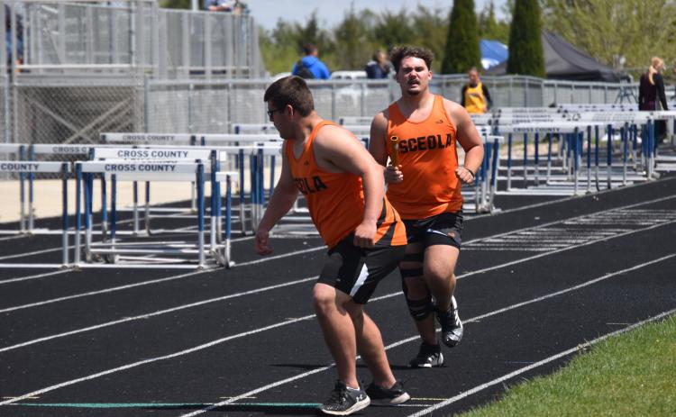 ABOVE: Bransen Lavaley hands off to Brenden Gabel in the 4x800-meter relay for Osceola. BELOW: Camryn Peterson (OSC), Olivia Adams (SRC) and Alexis Burritt (OSC) run in the 200m dash. PCN photos by Cienna Friesen.