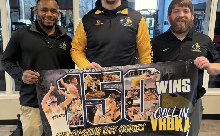 Collin Vrbka (center) is pictured with his coaches after his 150th win at the David City Invite. Vrbka is a senior at Shelby-Rising City. PCN photo by Jen Vrbka.