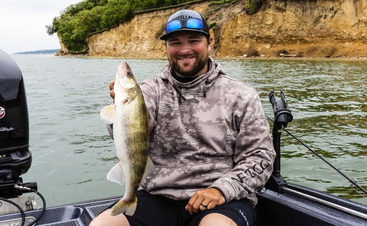 Mike Hamsa of Yutan, a fishing guide with The Walleye Guys, holds a walleye he caught while fishing on Lewis and Clark Lake State Recreation Area in Knox County. (Photo by Eric Fowler/of Nebraskaland Magazine/NGPC, and provided by Nebraska Game and Parks.)